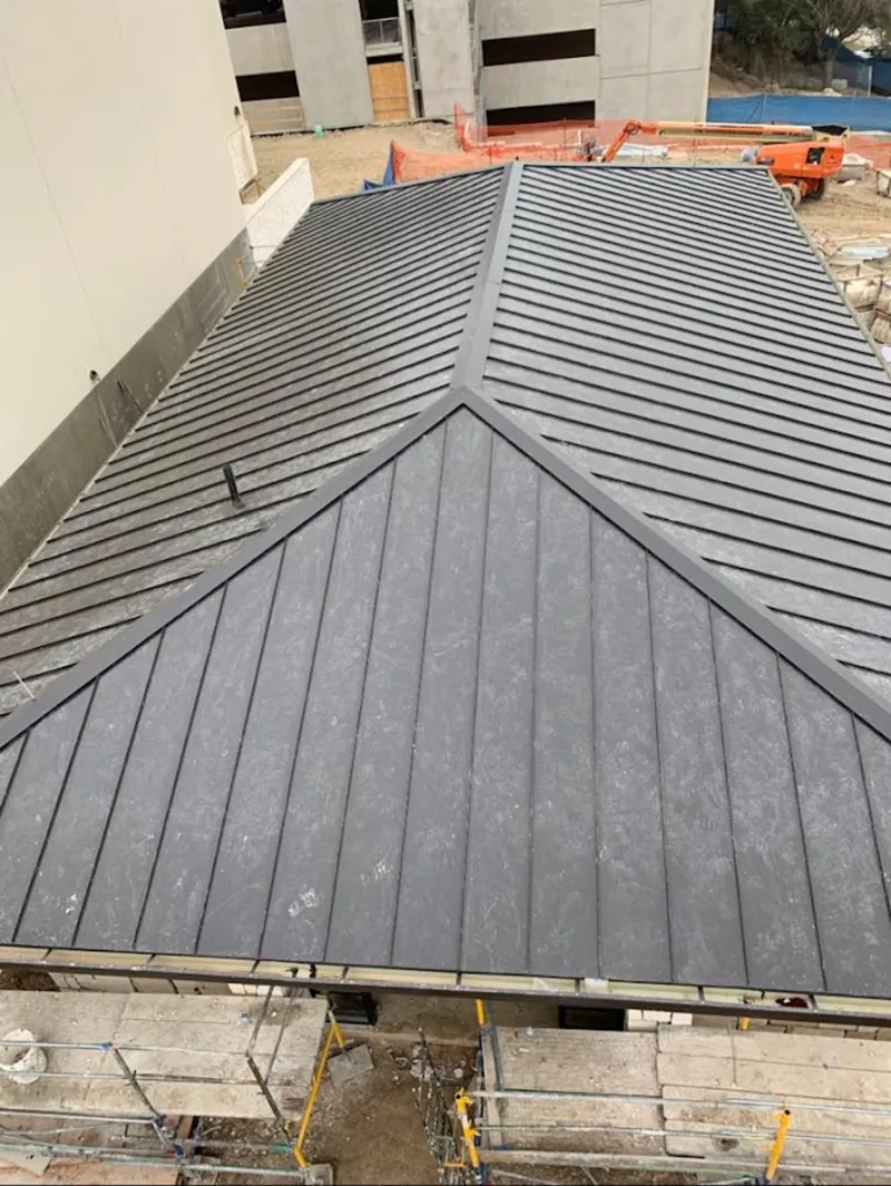 Commercial metal roof construction with crane equipment in South Barrington