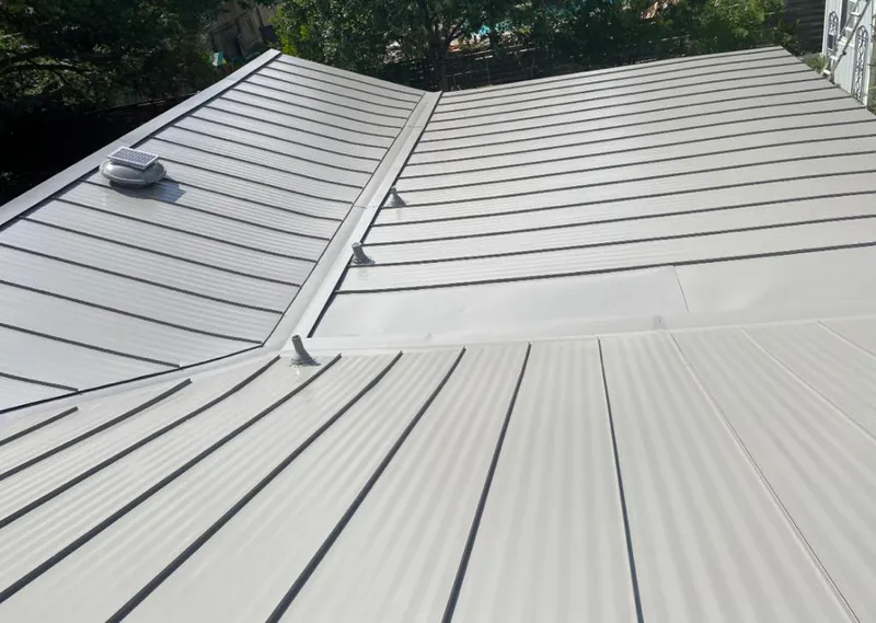 Solar attic fan installed on a metal roof for Roof Ventilation in South Barrington